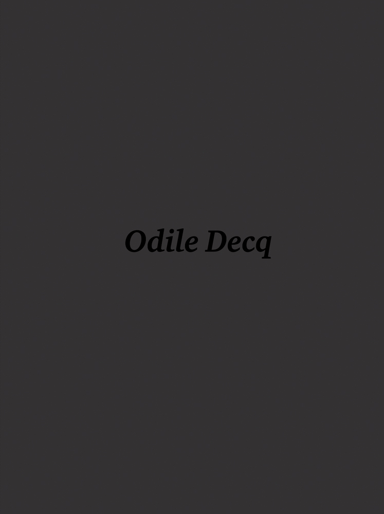 A plain charcoal grey background with Odile Decq in dark grey written in the centre