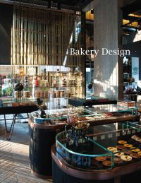 Bakery shop interior with glass display cabinets, cakes underneath, Bakery Design in white font to upper right.