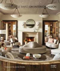 Beige interior space, central sofa, lit open fire, hanging light fittings, PENNY DRUE BAIRD On Interior Design in brown font above