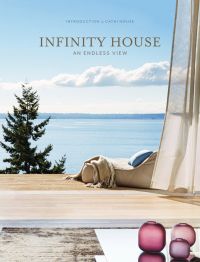 Relaxing view from interior, wooden decking, blue sky above sea with tree in foreground and Infinity House: An Endless View in gold font above