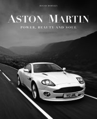 White Aston Martin V12 Vanquish on road, mountains behind, 'ASTON MARTIN', in white font above, by The Images Publishing Group.