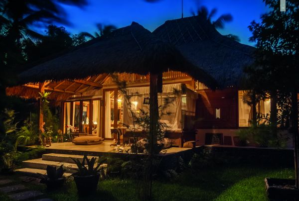 Book cover of Seen | Unseen: Embracing Natural Home Design in Bali, featuring a Balinese villa with thatched roof. Publishing by Images Publishing.