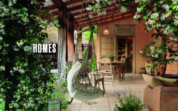 Book cover of Homes With Soul : Designing with Heart, with a wooden rocking chair on woven rug, cream walls and soft sofa. Published by Images Publishing.