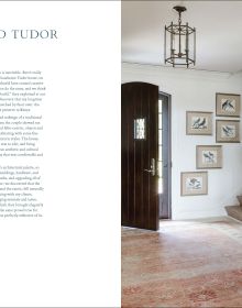 Book cover of An Adventurous Life: Global Interiors by Tom Stringer, with a white interior hallway with dark wood table with vases of flowers. Published by Images Publishing.