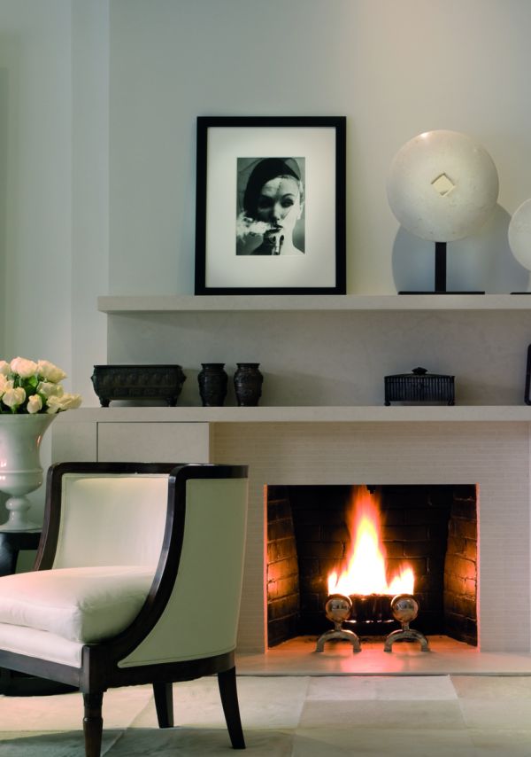 Book cover of On Interior Design featuring a beige interior space, with a sofa to centre, an open fire and hanging light fittings from ceiling. Published by Images Publishing.