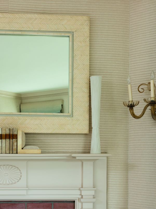 Book cover of On Interior Design featuring a beige interior space, with a sofa to centre, an open fire and hanging light fittings from ceiling. Published by Images Publishing.