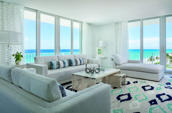 Book cover of On Interior Design featuring a beige interior space, with a sofa to centre, an open fire and hanging light fittings from ceiling. Published by Images Publishing.