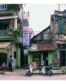 Book cover of Hanoi Streets 1985-2015: In the Years of Forgetting, with a push bike leaning against a shop in Vietnam. Published by Images Publishing.