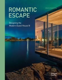 Book cover of Romantic Escape: Designing the Modern Guest House III, featuring a modern glass building on edge of blue lake, with northern lights above. Published by Images Publishing.