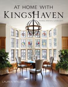 Light interior space, wood floor, table and chairs in front of large stained glass window, AT HOME WITH KINGSHAVEN in black font above.