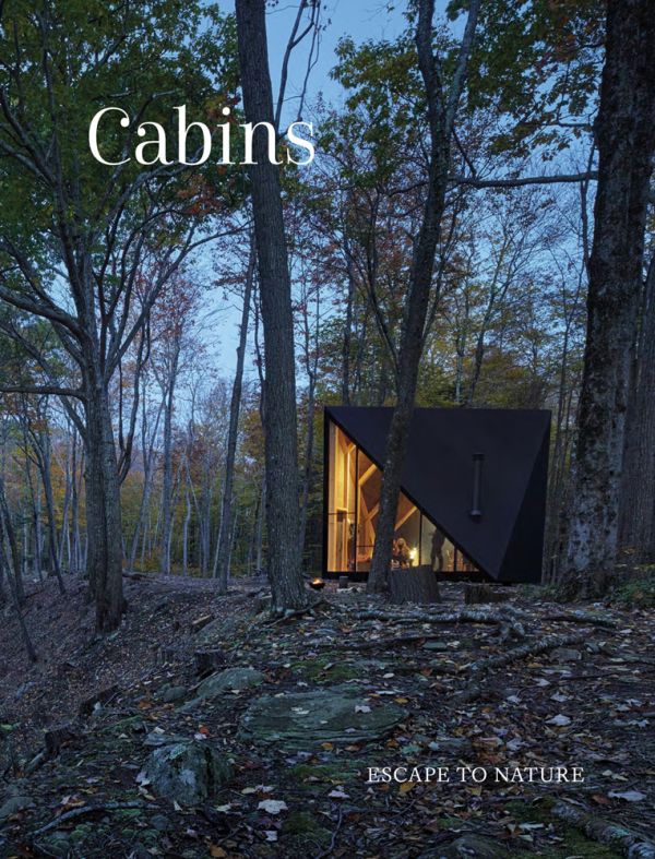 Book cover of Cabins: Escape to Nature, with modern cabin in a forest, with interior lights on. Published by Images Publishing.