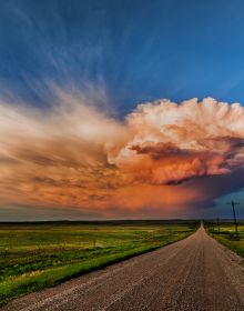Atmospheric dark storm cloud above landscape, sun light to far left, FIERCE BEAUTY Storms of the Great Plains in white font above.