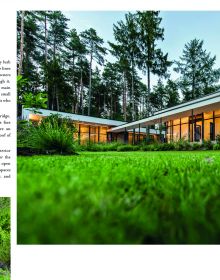 Interior space with wood slated panels revealing exterior landscape, 100 Houses NATURE AND NURTURE in brown font above.