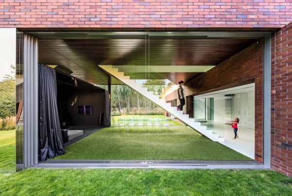 Book cover of Robert Konieczny: KWK Promes, buildings + ideas, with a modern family home resembling an ark, on green hillside. Published by Images Publishing.