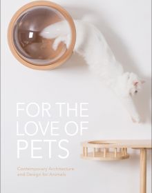 Fluffy white cat leaping out of clear dome doored bed inset in interior wall with For the Love of Pets in white font