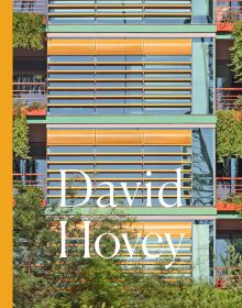 Close up of colourful architecture high rise building with orange window slats and green foliage cascading down window boxes and David Hovey in white font below