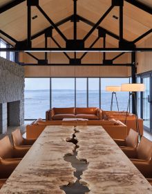 Book cover of Northern Hideaways, featuring a modern house with a flat roof of moss, poking out of the Canadian forest, with lake behind. Published by Images Publishing.