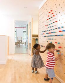 Book cover of Contemporary Creative Spaces for Children, featuring two boys playing on suspended multicolored webbing. Published by Images Publishing.