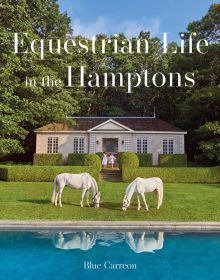 Two white horses grazing in front of single storey house, with topiary hedges, on cover of 'Equestrian Life in the Hamptons', by Images Publishing.