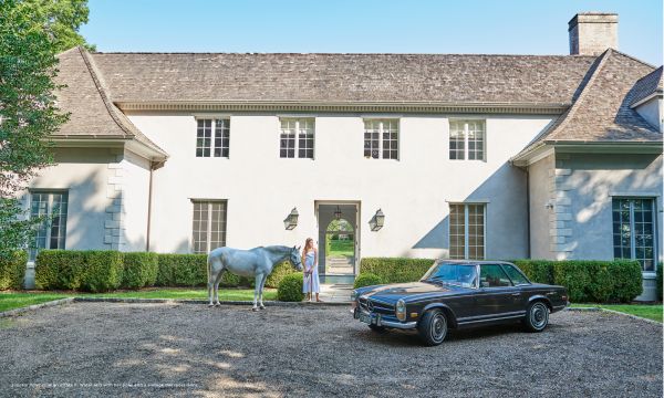 Book cover of Equestrian Life in the Hamptons, with two white horses grazing in front of house surrounded by topiary hedges. Published by Images Publishing.
