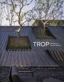 Book cover of TROP terrains + open space: Works 2007–2023, with the top of a building roof, with two spaces holding large trees. Published by Images Publishing.