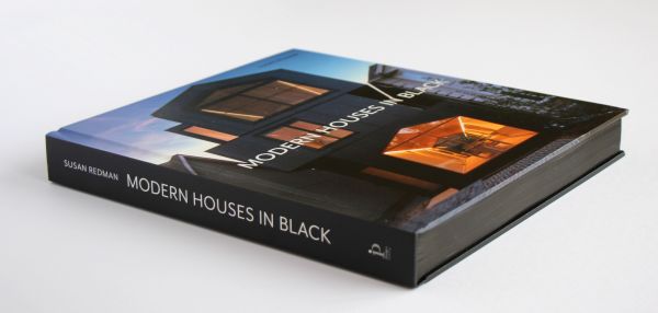 Book cover of Susan Redman's Modern Homes in Black, with a black wooden lake house in Berlin, surrounded by a garden. Published by Images Publishing.