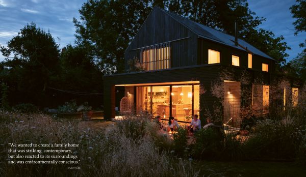 Book cover of Susan Redman's Modern Homes in Black, with a black wooden lake house in Berlin, surrounded by a garden. Published by Images Publishing.