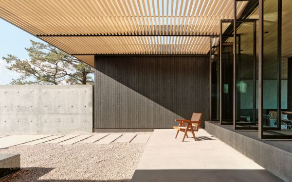 Book cover of Aidlin Darling Design's High Desert Retreat, with large rocks and roof structure behind. Published by Images Publishing.